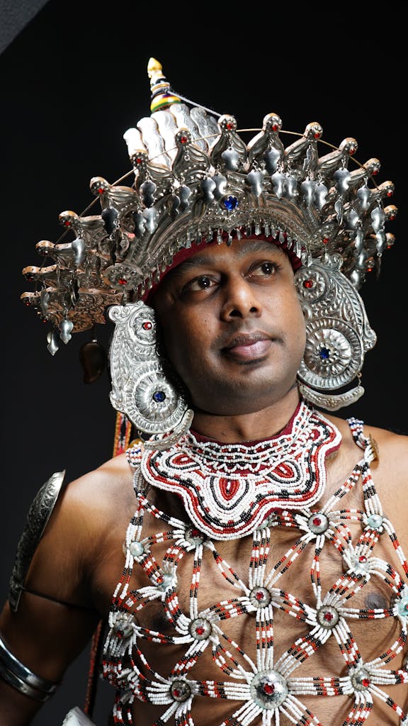 A traditional Kandyan dancer wearing an elaborate costume and crown in Sri Lanka.