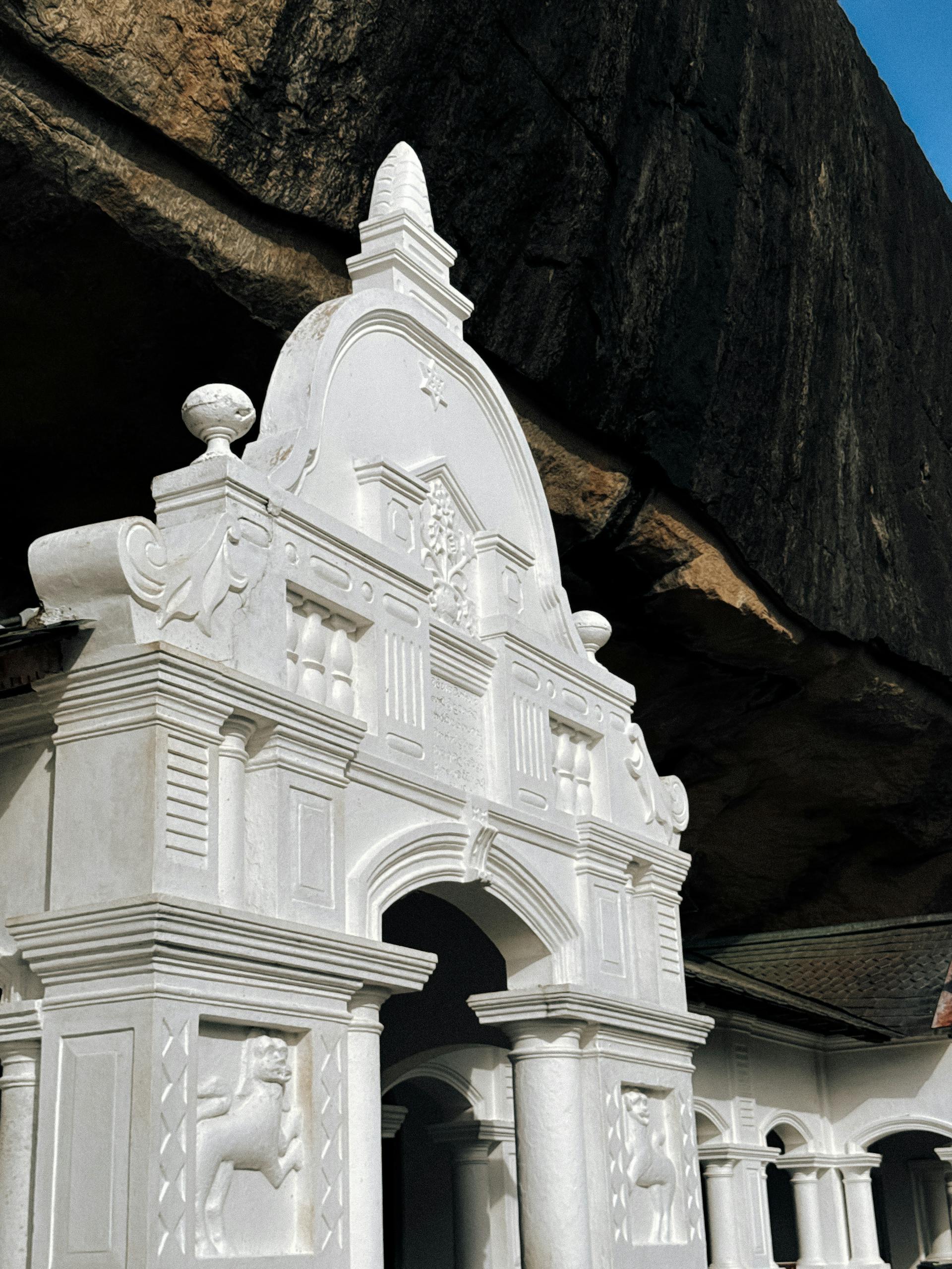 Detailed view of the white facade at Dambulla Cave Temple, a UNESCO World Heritage site in Sri Lanka.