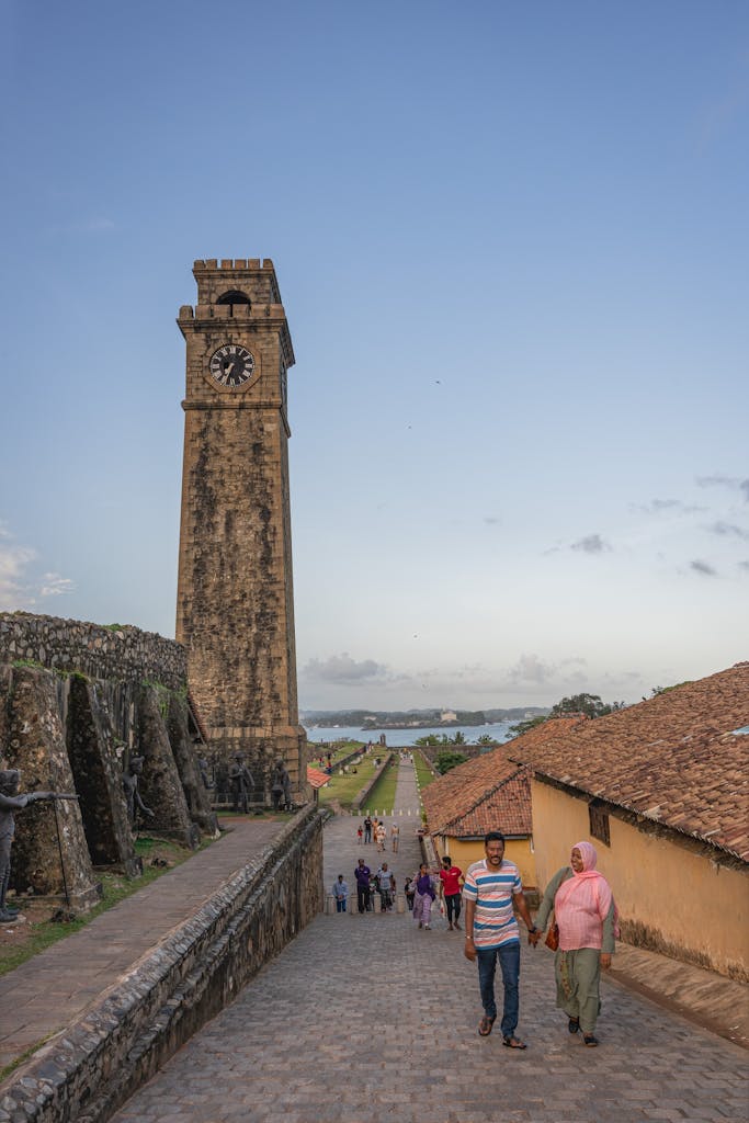 Scenic view of Galle Fort's iconic clock tower and cobbled pathways at sunset in Sri Lanka.